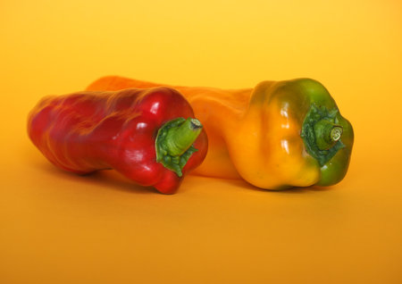 red and yellow peppers (scientific name Capsicum aka bell peppers) vegetables vegetarian foodの写真素材