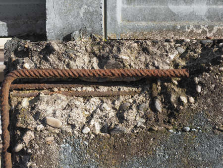 damaged reinforced concrete with exposed rusted steel resistance barsの写真素材