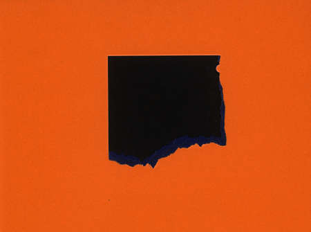 torn orange paper with black hole copy space
