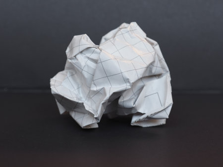 white paper ball over a dark grey background