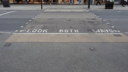 Look both ways sign at street crossing in Londonの写真素材