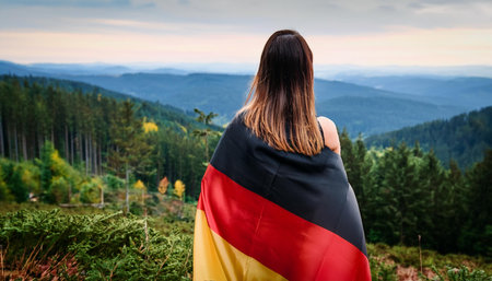 gorgeous woman wrapped in flag of germany, AI generated imageの写真素材