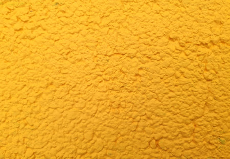 yellow painted tarmac texture useful as a backgroundの写真素材