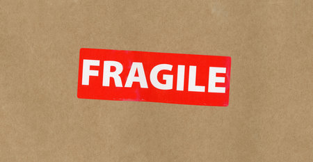 red fragile sign on brown paper backgroundの写真素材