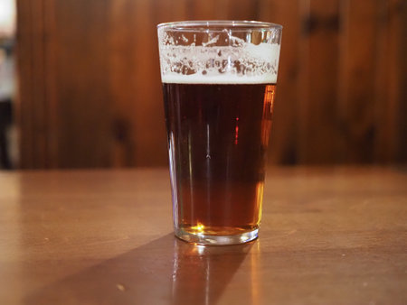 a pint of dark ale beer in a pubの写真素材