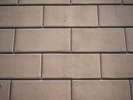 light brown ashlared wall useful as a background