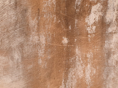 weathered brown plaster wall useful as a backgroundの写真素材