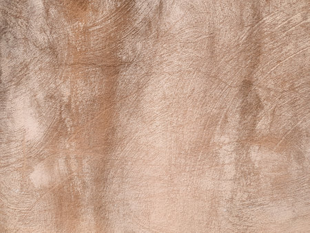 weathered brown plaster wall useful as a backgroundの写真素材