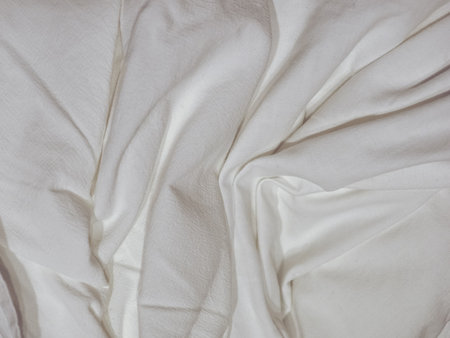 crumpled white cotton fabric texture useful as a backgroundの写真素材