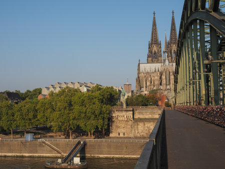 Hohenzollernbruecke (meaning Hohenzollern Bridge) crossing the river Rhein in Koeln, Germanyの写真素材