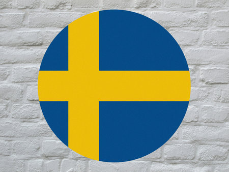 round Swedish national flag of Sweden, Europe over white bricks wallの写真素材