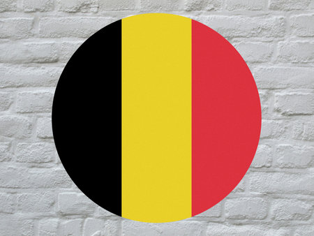 round Belgian national flag of Belgium, Europe over white bricks wallの写真素材