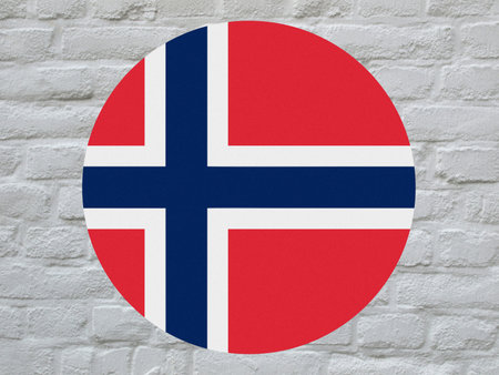 round Norwegian national flag of Norway, Europe over white bricks wallの写真素材