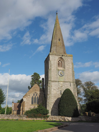The Village Green with St Mary Magdalene church and war memorial in Tanworth in Arden, UKの写真素材