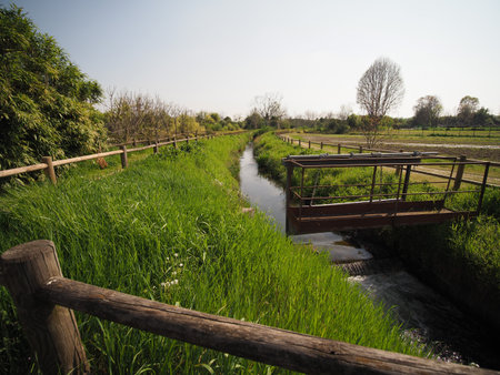water canal in the grass with water lockの写真素材