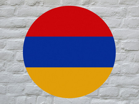 round Armenian national flag of Armenia, Europe over white bricks wallの写真素材