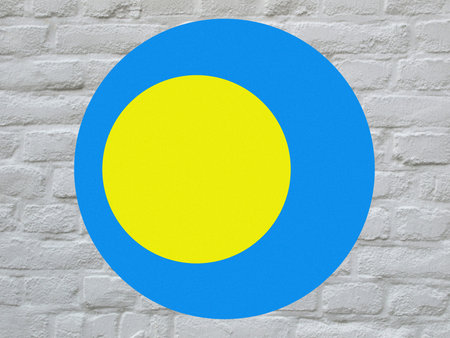 round Palauan national flag of Palau, Oceania over white bricks wallの写真素材