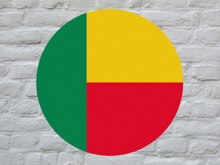 round Beninese national flag of Benin, Africa over white bricks wallの写真素材