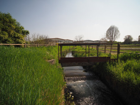 water canal in the grass with water lockの写真素材