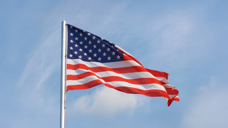 the American national flag of United States of America over blue sky