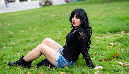 pretty young goth woman sitting on the grass, AI generated imageの素材