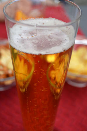  Glass of beer and snacks in red background の写真素材