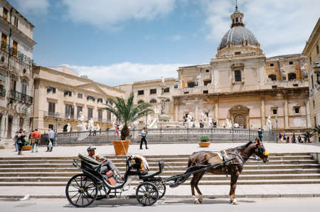 Palermo, Italy - May 12, 2016: Coachman with horse and carriage waiting for the tourists in front of the Pretoria fountain, Palermo Italyのeditorial素材