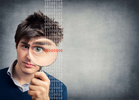 Young Man with magnifying glass lookingの写真素材