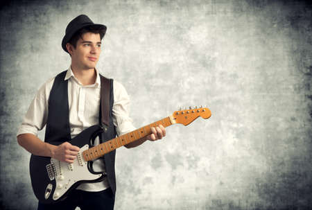 Young man playing electric guitarの写真素材