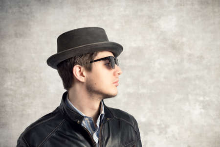 Young stylish man with hat and sunglassesの写真素材