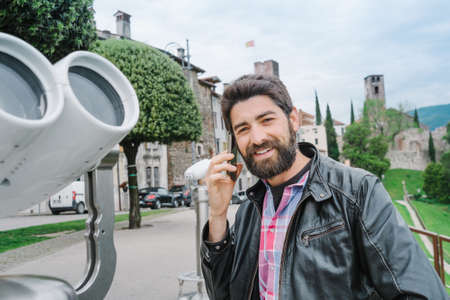 Portrait of a bearded young man with a phoneの写真素材