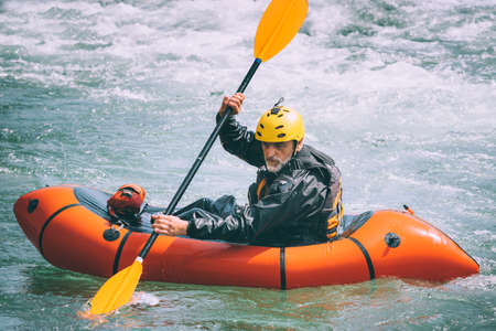 Senior man practicing raftingの写真素材