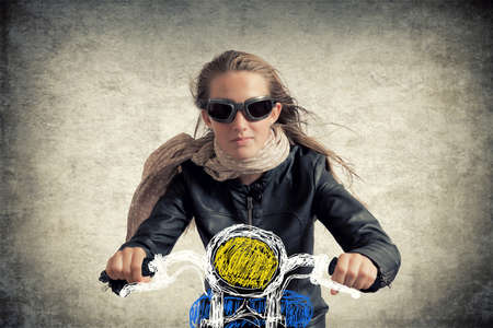 teen girl pretending to ride a motorcycle