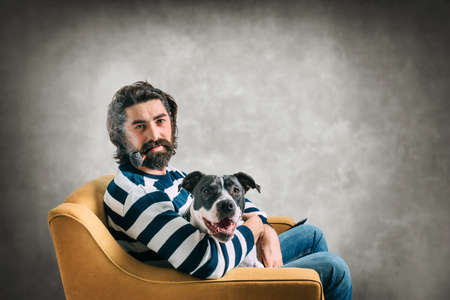 Bearded young man with his dogの写真素材