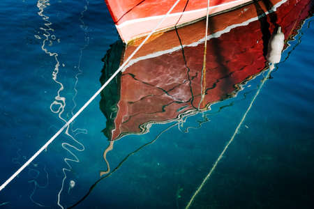 Reflections of a boat on the waterの写真素材