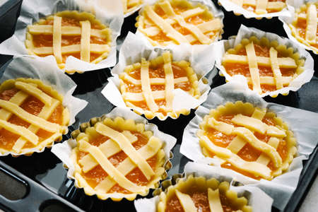 Preparing pies with pastry and jamの写真素材