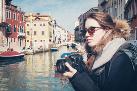 Teen girl with camera in Veniceの写真素材