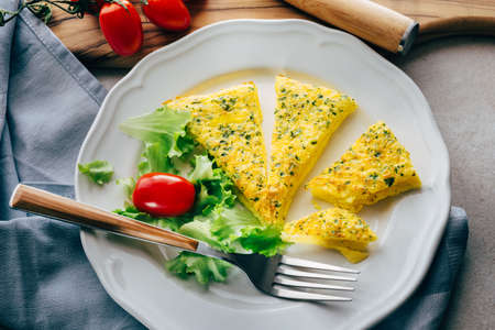 Omelette cooked in the oven, parmesan and parsleyの写真素材