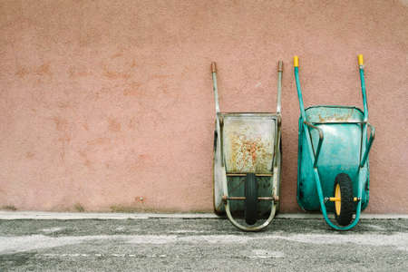 wheelbarrows leaning against the wallの写真素材