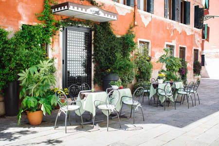 Venice, Italy - 20, April 2017: tables and chairs in front of the hotel entrance door Marin.のeditorial素材