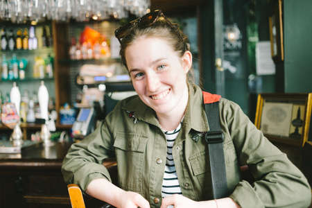 Smiling young teen woman in a pubの写真素材