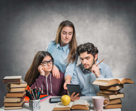 Young students reading an ebookの写真素材