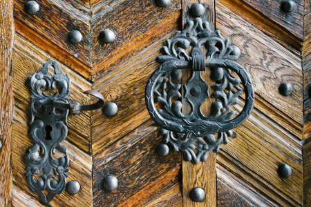 Detail of the lock and handle of an old wooden doorの写真素材