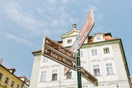 Prague, Czech Republic - May 23rd, 2018: tourist indications on road signs in front of a white decorated palaceのeditorial素材