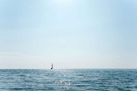 sailboat that is sailing in the middle of the sea on a sunny dayの写真素材