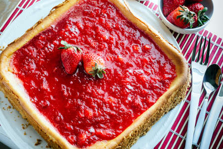 Cheesecake with strawberry jelly on white plate.の写真素材