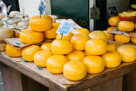 Amsterdam, Netherlands - May 13, 2019: typical Dutch cheese on the benches outside the shopのeditorial素材
