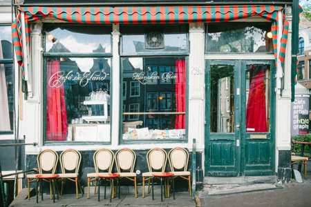 Amsterdam, Netherlands - May 13, 2019: external view of a bar-cafe with outdoor tables and chairsのeditorial素材