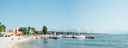 Padenghe del Garda, Italy - Sunday 1 September 2019: marina and bathers on the shores of Lake Garda on a sunny morningのeditorial素材