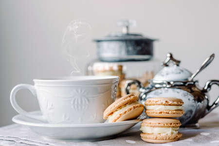Homemade macarons pastries with custard on the table - close up